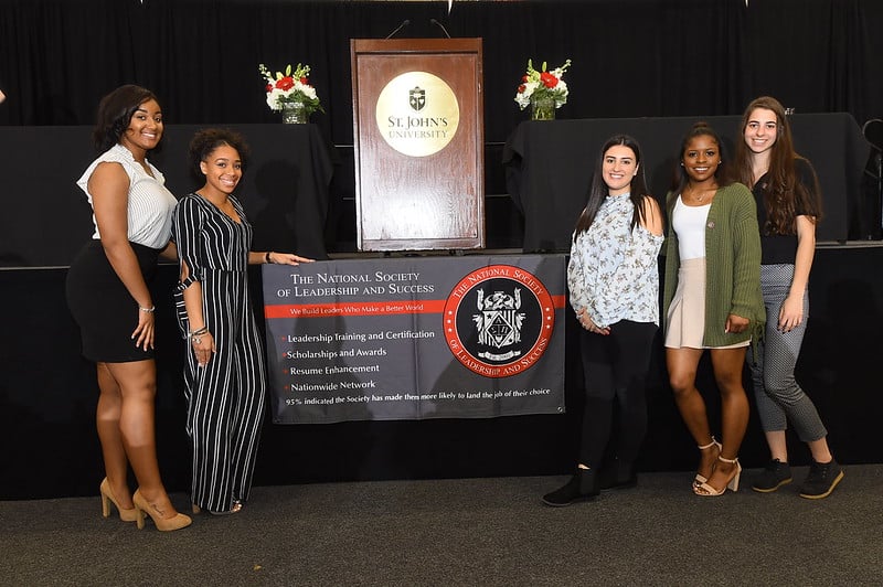 NSLS students posing for a photo in front of an NSLS banner NSLS students posing for a photo in front of an NSLS banner