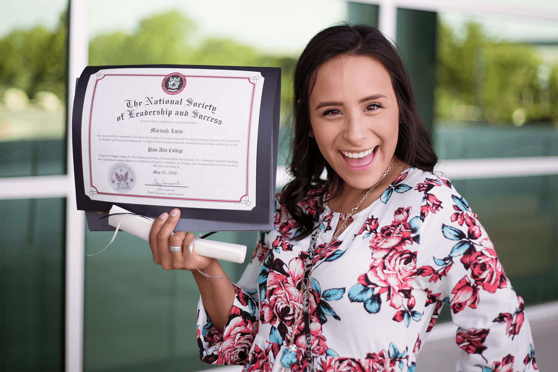 NSLS Member Holding Up Their Induction Certificate.