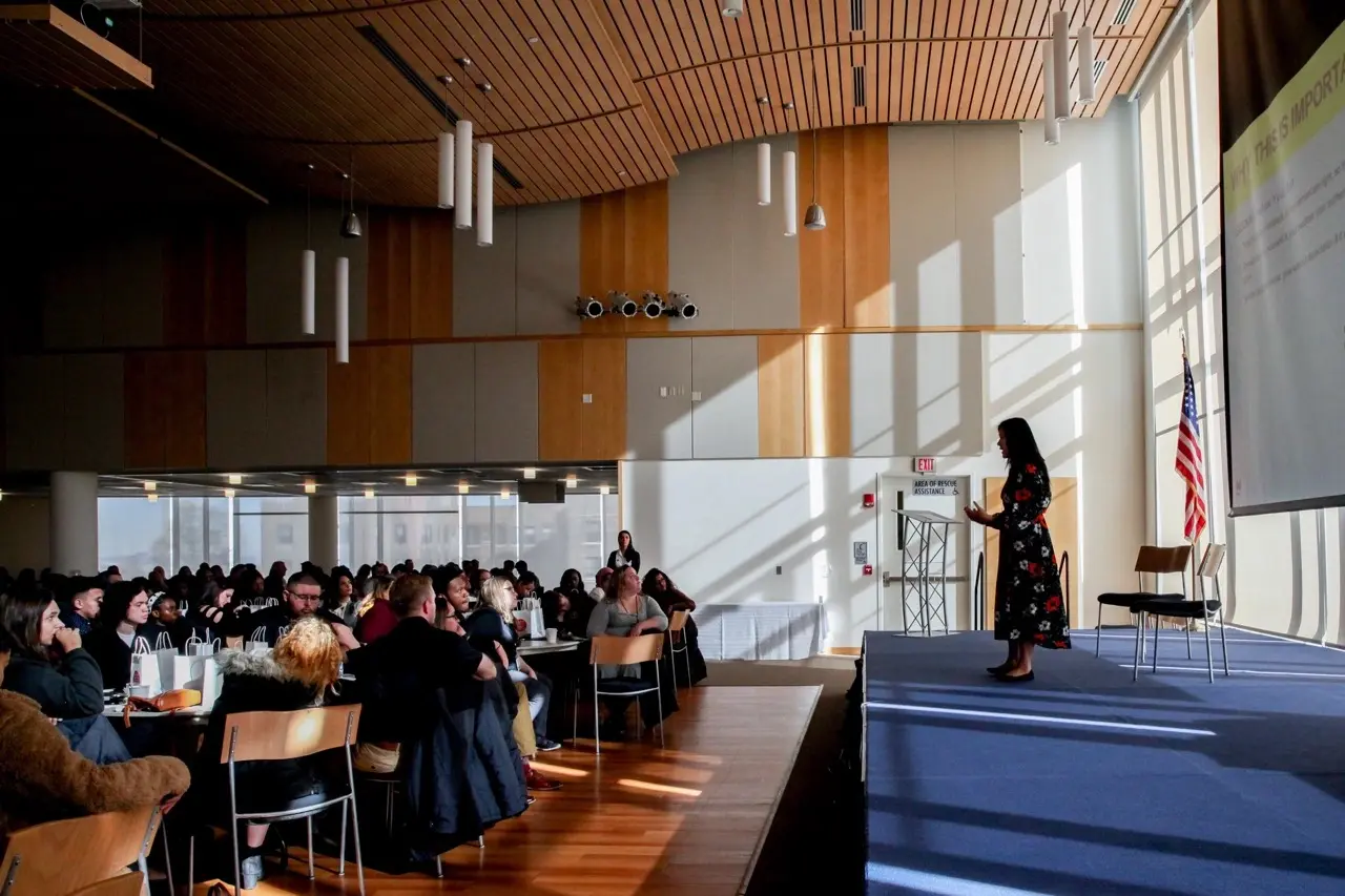 Instructor Giving Presentation at Conference.